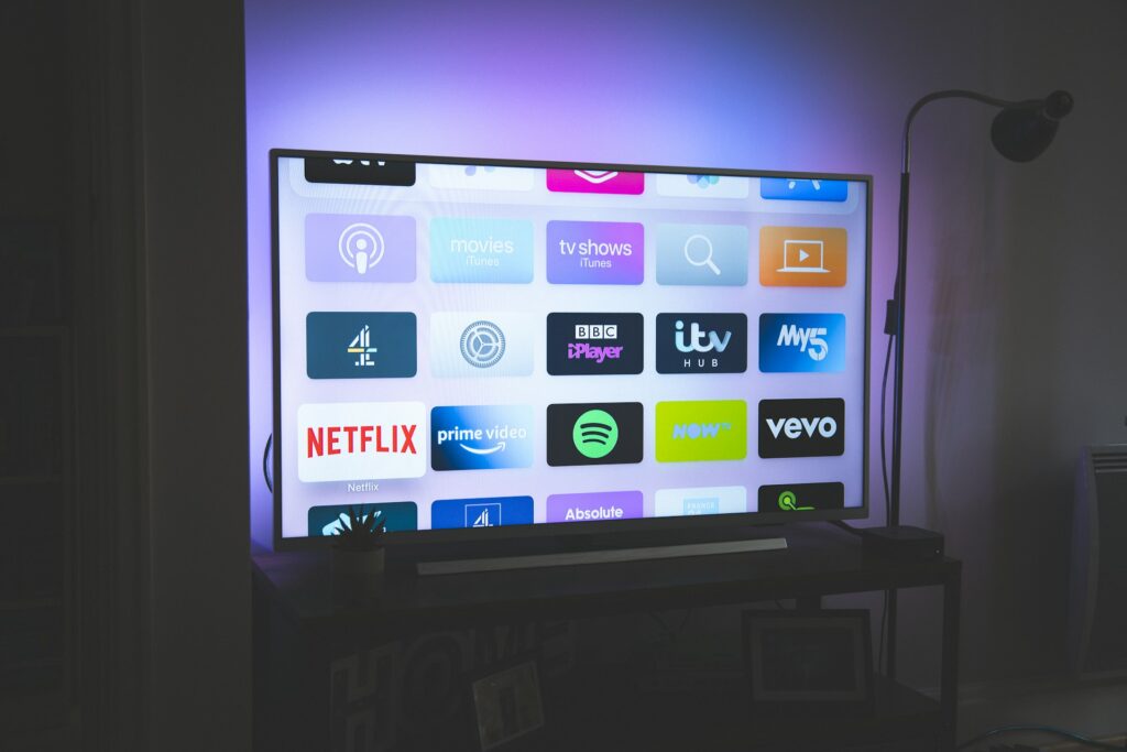 Illustration of programmatic CTV advertising featuring smart TV screens, audience segmentation, and real-time ad buying technology.