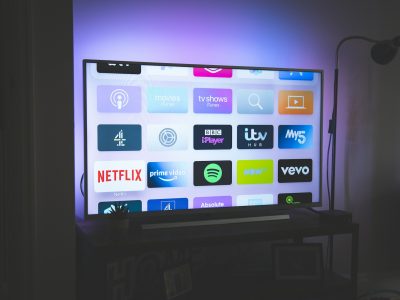 Illustration of programmatic CTV advertising featuring smart TV screens, audience segmentation, and real-time ad buying technology.